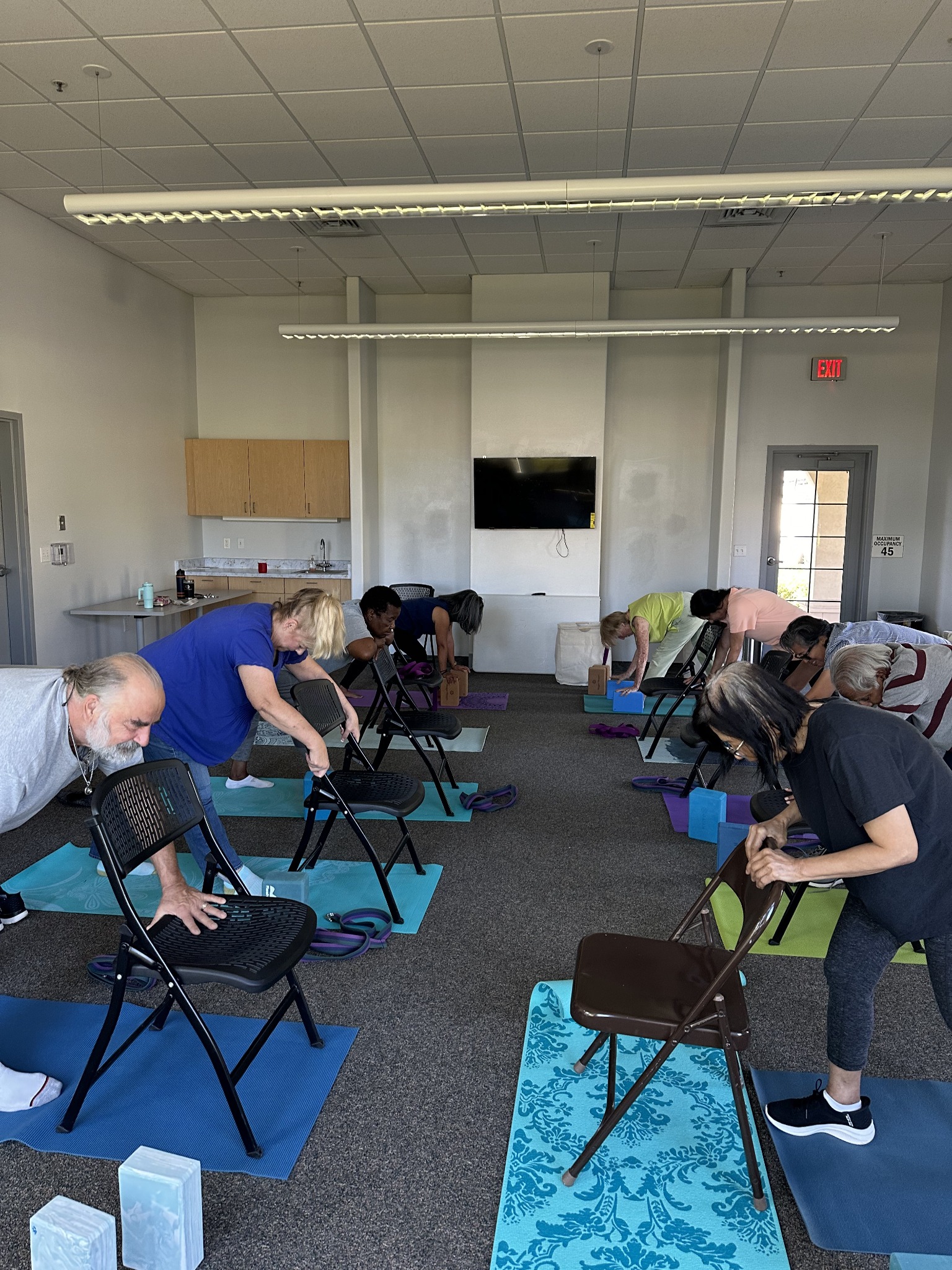 Older adults participating in a community chair yoga class