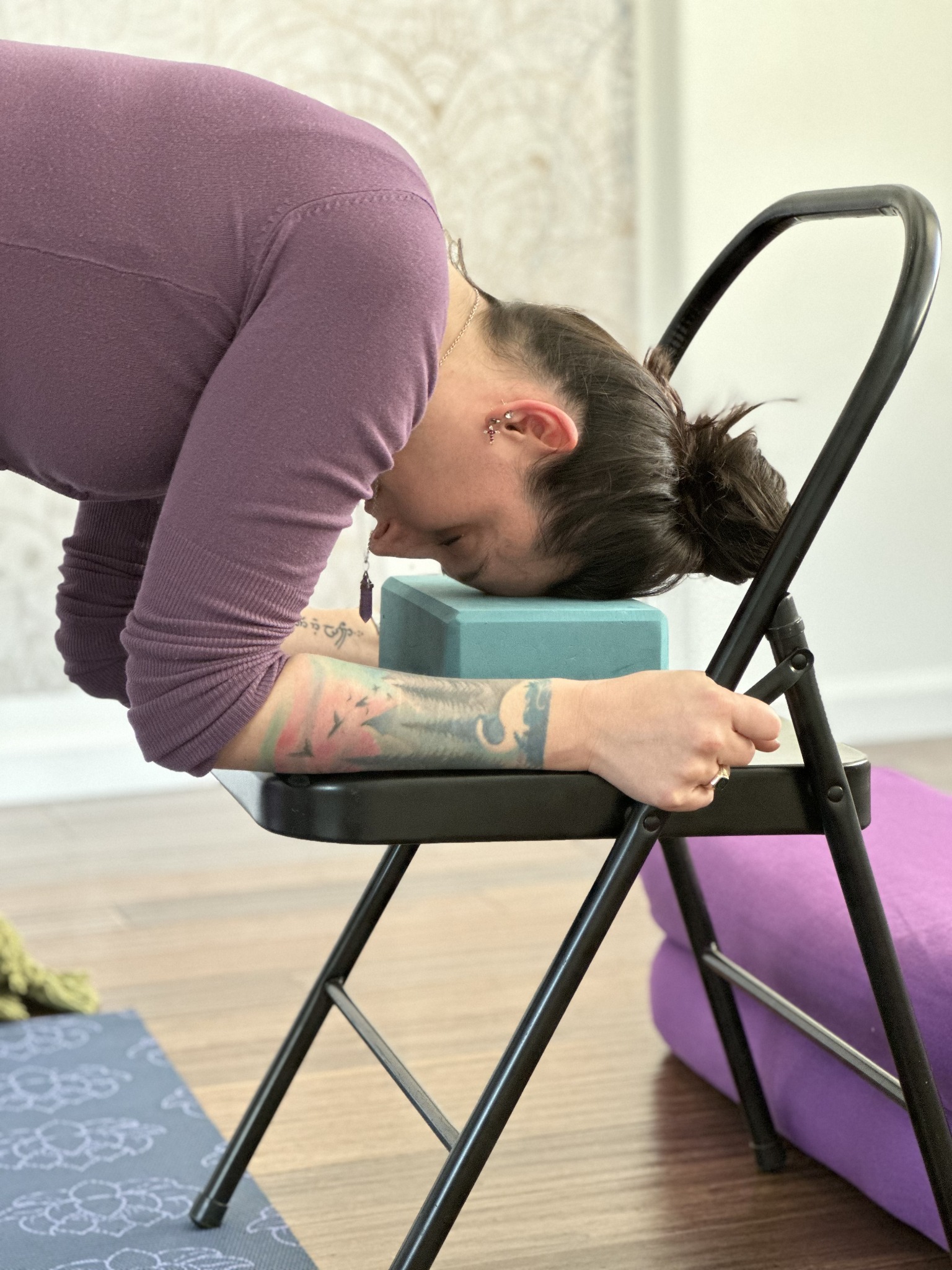 An adult using chair and bolster support